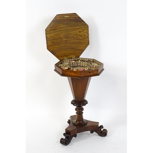 1563 - A Victorian walnut trumpet shaped work table / sewing table with an inlaid octagonal top raised on t... 