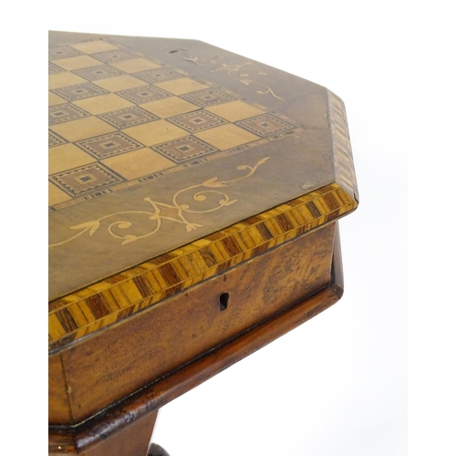 1563 - A Victorian walnut trumpet shaped work table / sewing table with an inlaid octagonal top raised on t... 