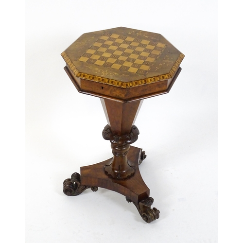 1563 - A Victorian walnut trumpet shaped work table / sewing table with an inlaid octagonal top raised on t... 