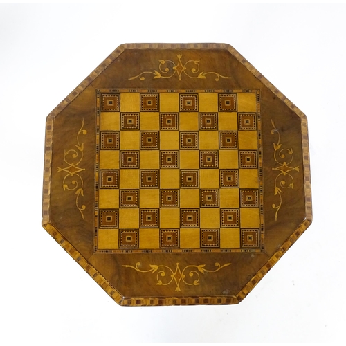 1563 - A Victorian walnut trumpet shaped work table / sewing table with an inlaid octagonal top raised on t... 