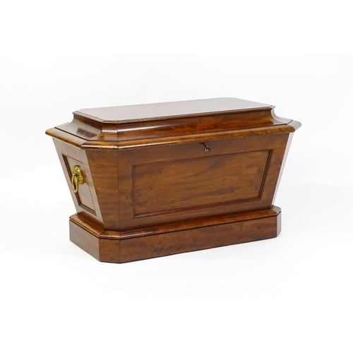 1568 - An early 19thC mahogany wine cooler of sarcophagus form with a moulded hinged lid above a panelled f... 