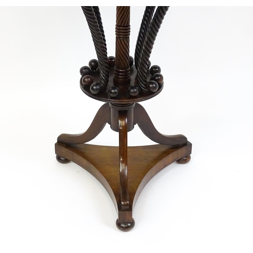 1570 - An early / mid 19thC unusual table with a laburnum top having four short drawers above five rope tur... 