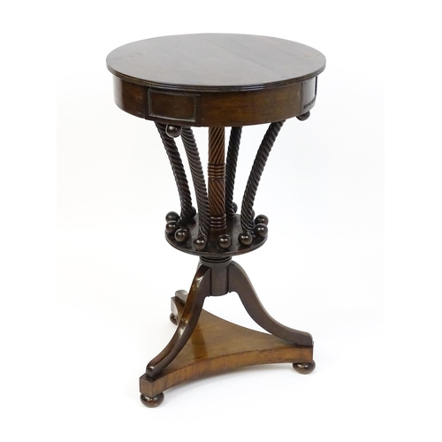 1570 - An early / mid 19thC unusual table with a laburnum top having four short drawers above five rope tur... 