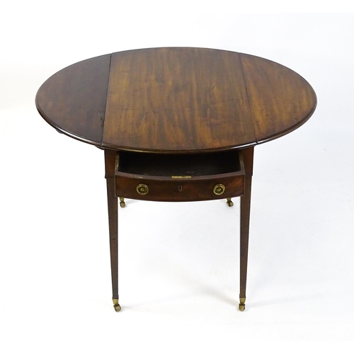 1595 - An early 19thC mahogany Pembroke table with two demi lune leaves flanking a single short drawer to o... 