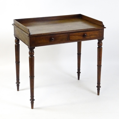 1596 - A Victorian mahogany table with a shaped upstand above two short drawers with turned knob handles an... 