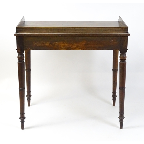 1596 - A Victorian mahogany table with a shaped upstand above two short drawers with turned knob handles an... 