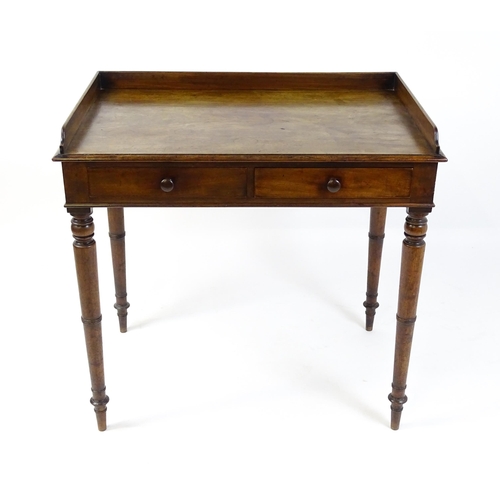 1596 - A Victorian mahogany table with a shaped upstand above two short drawers with turned knob handles an... 