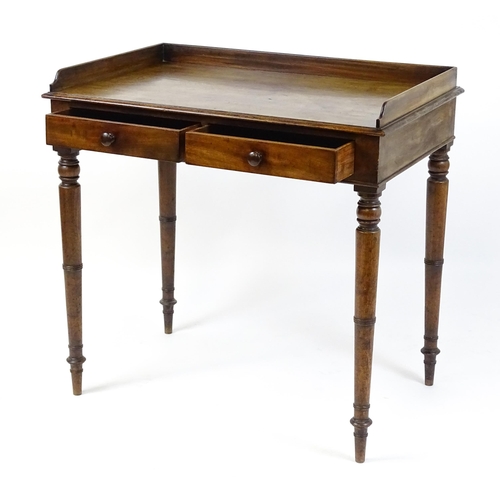 1596 - A Victorian mahogany table with a shaped upstand above two short drawers with turned knob handles an... 