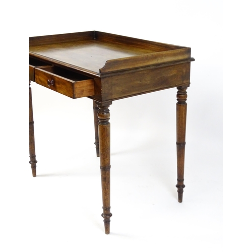 1596 - A Victorian mahogany table with a shaped upstand above two short drawers with turned knob handles an... 