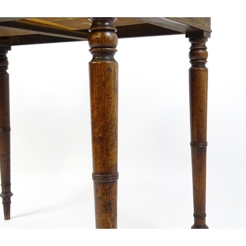 1596 - A Victorian mahogany table with a shaped upstand above two short drawers with turned knob handles an... 