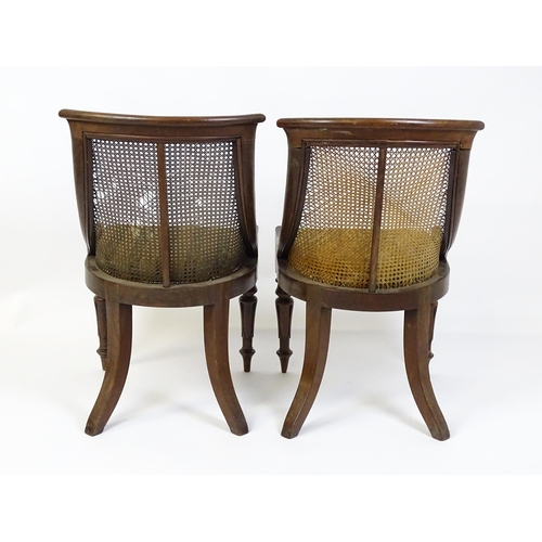 1598 - A pair of 19thC mahogany Gillows style bergère chairs with caned and bowed backrests above drop in s... 