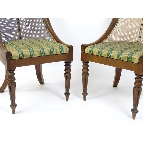 1598 - A pair of 19thC mahogany Gillows style bergère chairs with caned and bowed backrests above drop in s... 