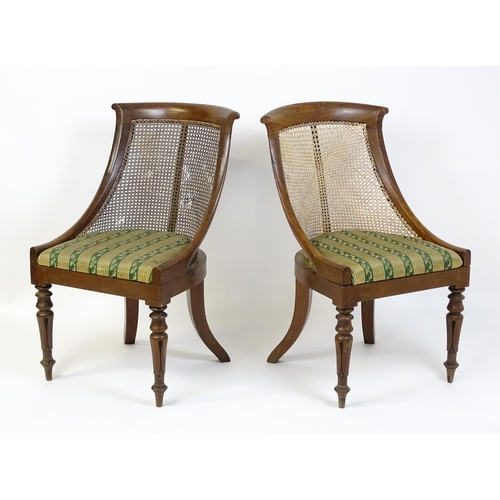 1598 - A pair of 19thC mahogany Gillows style bergère chairs with caned and bowed backrests above drop in s... 