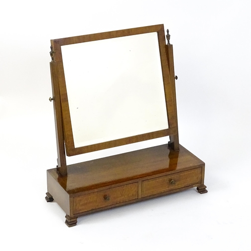 1604 - A late 19thC / early 20thC mahogany and satinwood crossbanded mirror having a square glass flanked b... 