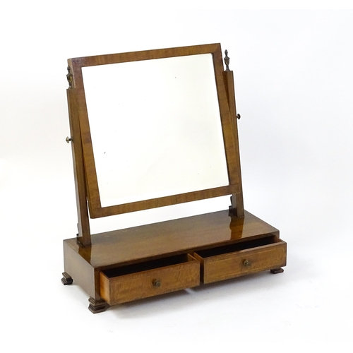 1604 - A late 19thC / early 20thC mahogany and satinwood crossbanded mirror having a square glass flanked b... 