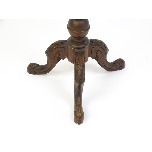 1605 - A late 19thC tripod table with a carved rim above a turned pedestal and three carved cabriole legs. ... 