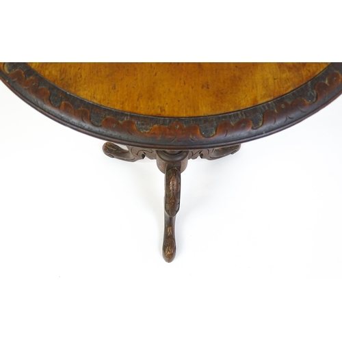 1605 - A late 19thC tripod table with a carved rim above a turned pedestal and three carved cabriole legs. ... 