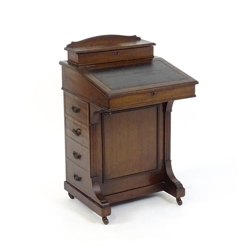 1612 - An Edwardian mahogany Davenport with a hinged writing compartment above a leather topped slope, the ... 