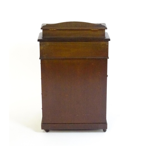 1612 - An Edwardian mahogany Davenport with a hinged writing compartment above a leather topped slope, the ... 