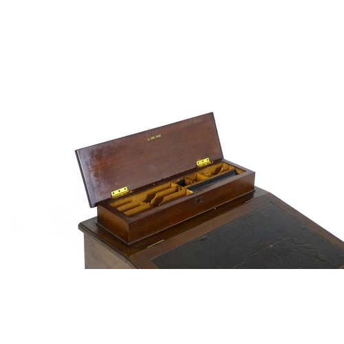 1612 - An Edwardian mahogany Davenport with a hinged writing compartment above a leather topped slope, the ... 