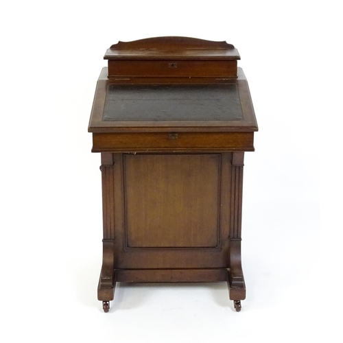 1612 - An Edwardian mahogany Davenport with a hinged writing compartment above a leather topped slope, the ... 