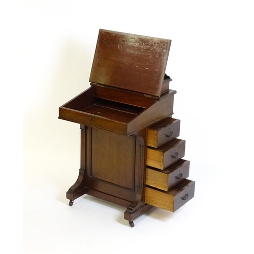 1612 - An Edwardian mahogany Davenport with a hinged writing compartment above a leather topped slope, the ... 