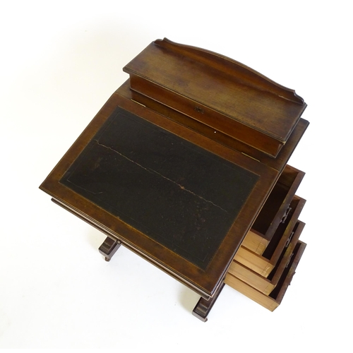 1612 - An Edwardian mahogany Davenport with a hinged writing compartment above a leather topped slope, the ... 