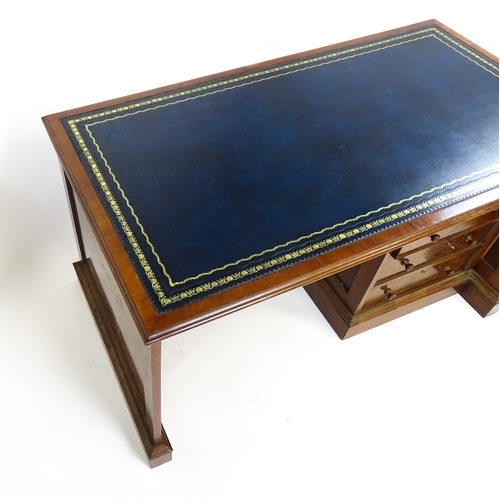 1631 - A mid / late 20thC desk with a gold tooled leather top. 54