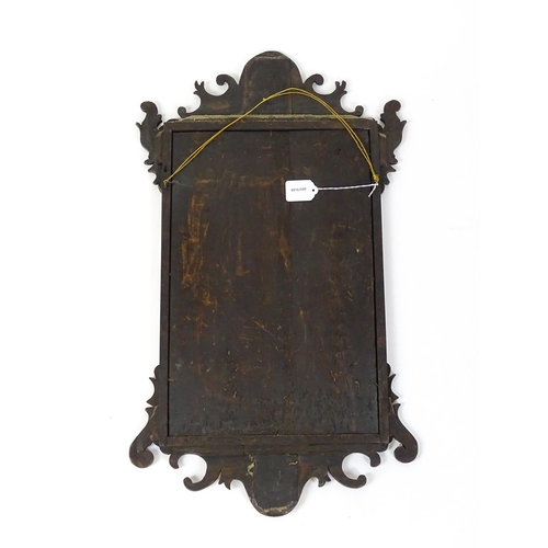 1636 - A late 19thC / early 20thC mahogany wall mirror with scrolled detailing and a moulded surround. 16