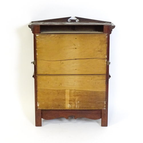 1637 - An early 20thC mahogany wall hanging cabinet with a neo - classical style pediment above a dentil mo... 