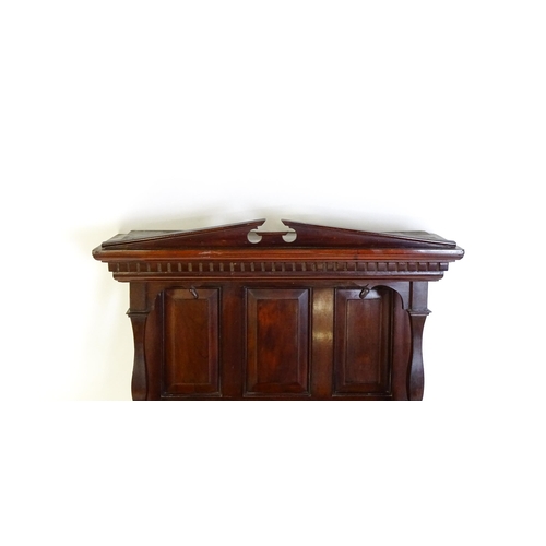 1637 - An early 20thC mahogany wall hanging cabinet with a neo - classical style pediment above a dentil mo... 