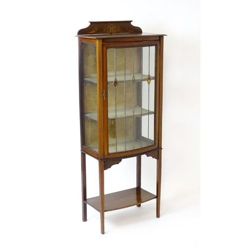 1641 - An Edwardian mahogany display cabinet with a marquetry inlaid upstand with a single glazed door, hav... 