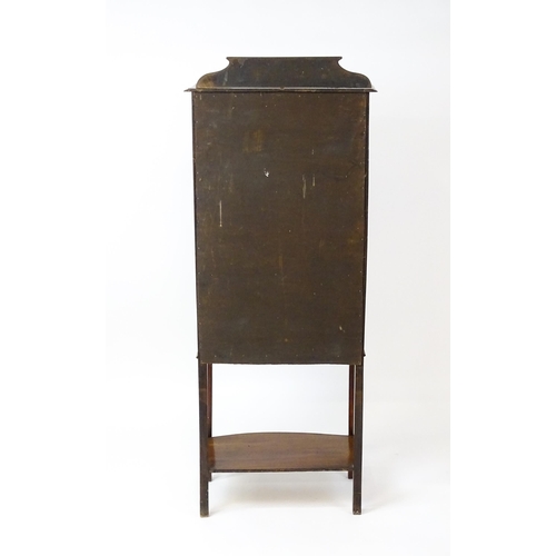 1641 - An Edwardian mahogany display cabinet with a marquetry inlaid upstand with a single glazed door, hav... 