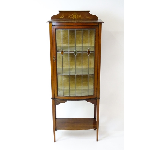 1641 - An Edwardian mahogany display cabinet with a marquetry inlaid upstand with a single glazed door, hav... 