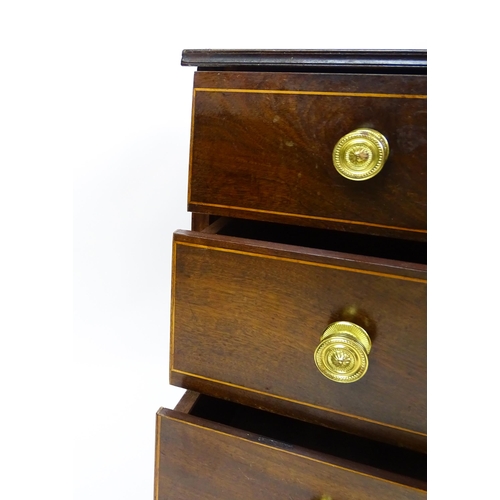 1642 - An early 20thC mahogany chest of drawers with a rectangular top above four long drawers with brass k... 