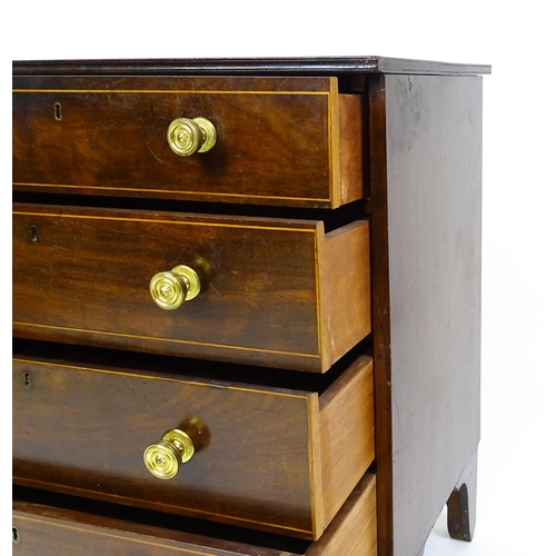 1642 - An early 20thC mahogany chest of drawers with a rectangular top above four long drawers with brass k... 