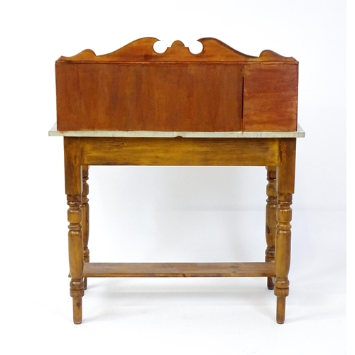 1647 - An early 20thC washstand with a tiled splashback above a marble top raised on four turned tapering l... 