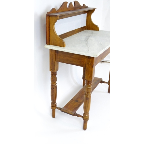 1647 - An early 20thC washstand with a tiled splashback above a marble top raised on four turned tapering l... 