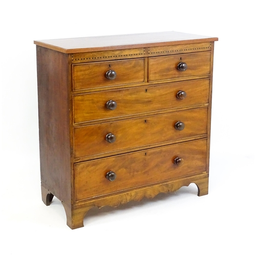 1649 - A mid / late 19thC mahogany chest of drawers with an inlaid frieze above two short over three long d... 