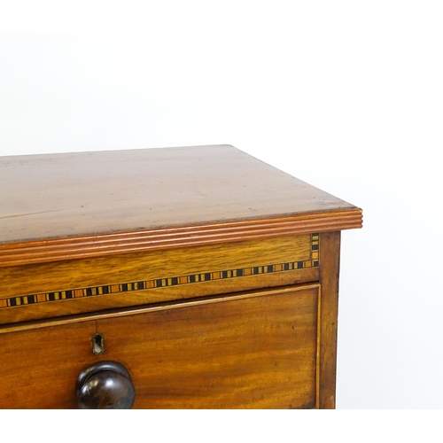 1649 - A mid / late 19thC mahogany chest of drawers with an inlaid frieze above two short over three long d... 