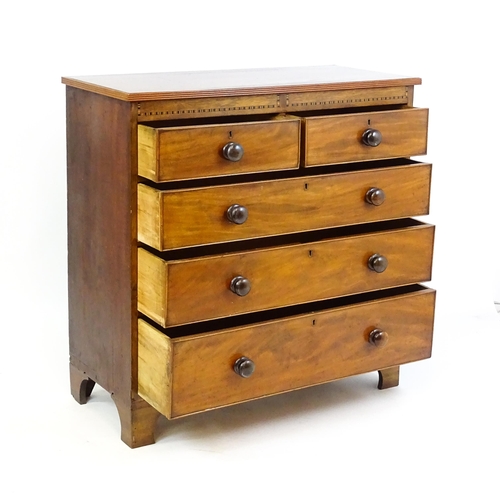 1649 - A mid / late 19thC mahogany chest of drawers with an inlaid frieze above two short over three long d... 