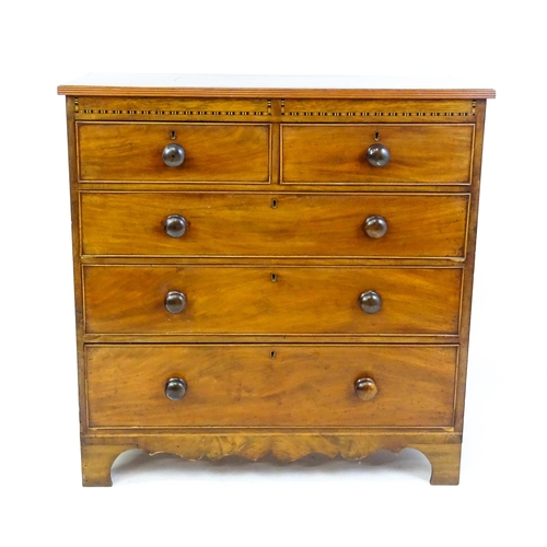 1649 - A mid / late 19thC mahogany chest of drawers with an inlaid frieze above two short over three long d... 