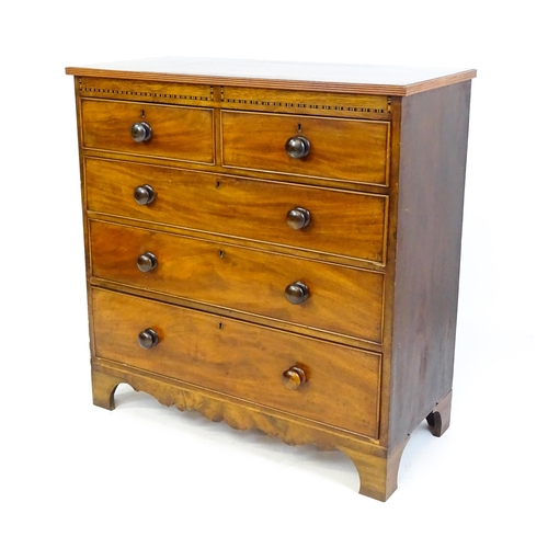 1649 - A mid / late 19thC mahogany chest of drawers with an inlaid frieze above two short over three long d... 