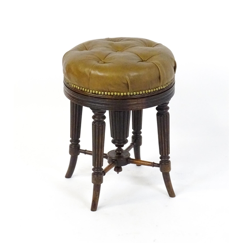 1656 - A 19thC rosewood adjustable piano stool with a leather deep buttoned top raised on four reeded taper... 