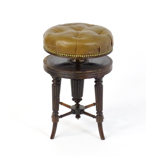 1656 - A 19thC rosewood adjustable piano stool with a leather deep buttoned top raised on four reeded taper... 