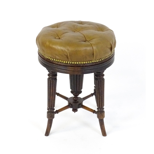 1656 - A 19thC rosewood adjustable piano stool with a leather deep buttoned top raised on four reeded taper... 