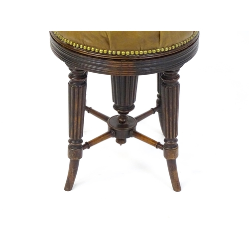 1656 - A 19thC rosewood adjustable piano stool with a leather deep buttoned top raised on four reeded taper... 