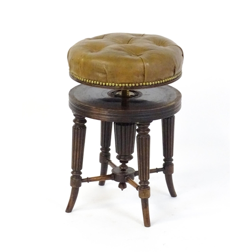 1656 - A 19thC rosewood adjustable piano stool with a leather deep buttoned top raised on four reeded taper... 