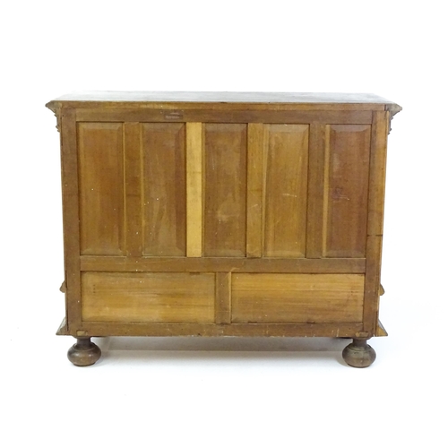 1660 - A late 19thC / early 20thC walnut cupboard with a moulded top above two panelled doors and a fluted ... 