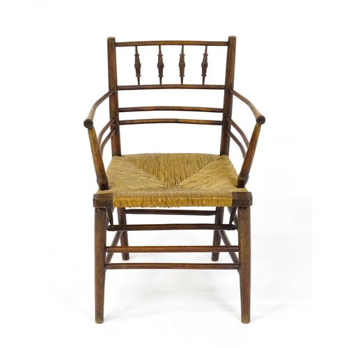 1667 - A late 19thC Arts & Crafts Sussex chair by William Morris. The chair with a spindle turned and doubl... 